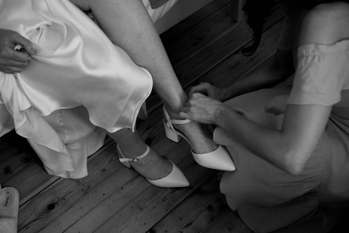 Bride putting on shoes on wedding day